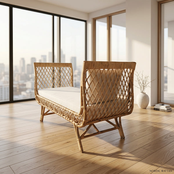 A natural rattan daybed with a woven diamond-pattern backrest and seat cushion, isolated on a white background.