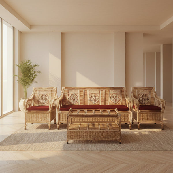 Wicker outdoor furniture set with red cushions on a stone patio.